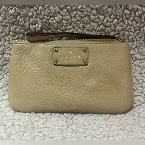 SOLD Kate Spade medium size wristlet, beige in color. with blue interior.